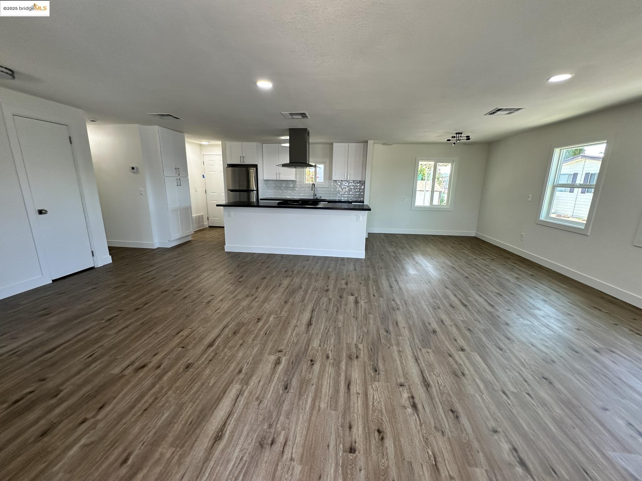 3301 Buchanan Road, Unit 47 Antioch, CA 94509 - Photo 18 of 58 Unfurnished living room featuring dark wood-style flooring and recessed lighting