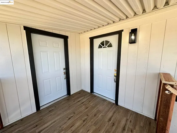 a view of hallway with wooden floor