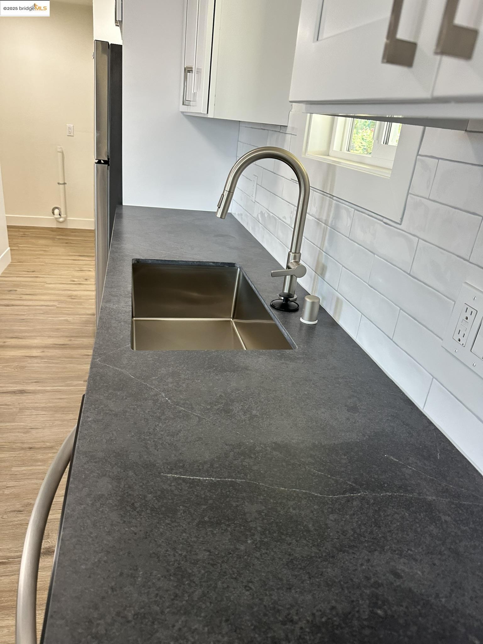 3301 Buchanan Road, Unit 47 Antioch, CA 94509 - Photo 28 of 58 Kitchen view of dark countertops, wood finished floors, and white cabinetry