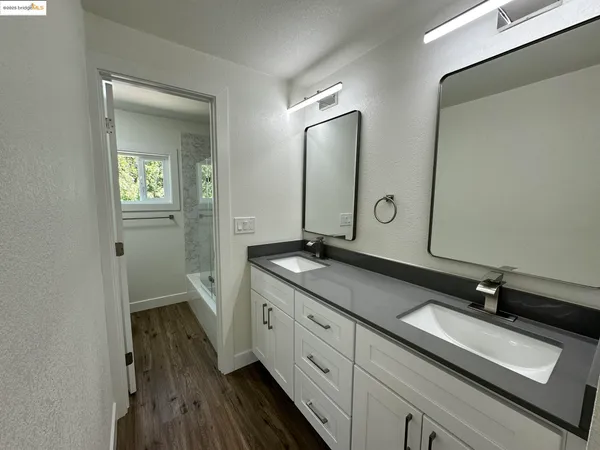a kitchen with granite countertop a refrigerator and a stove