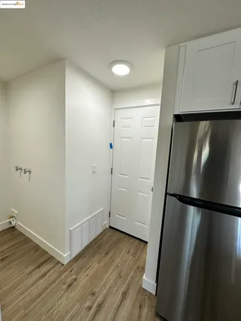 a view of a room with wooden floor and white walls