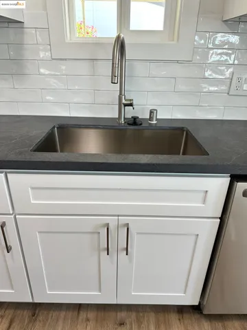 a view of hallway with wooden floor and staircase