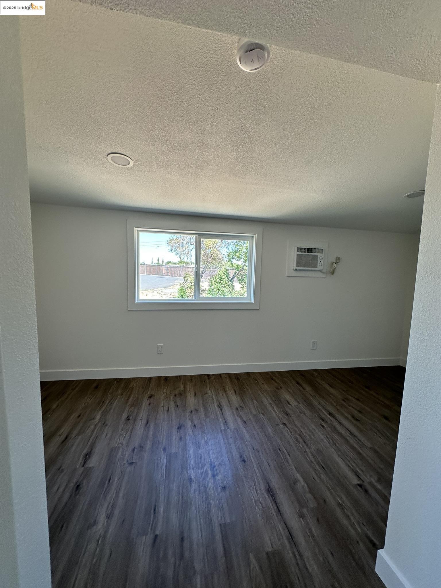 3301 Buchanan Road, Unit 47 Antioch, CA 94509 - Photo 40 of 58 an empty room with wooden floor and windows