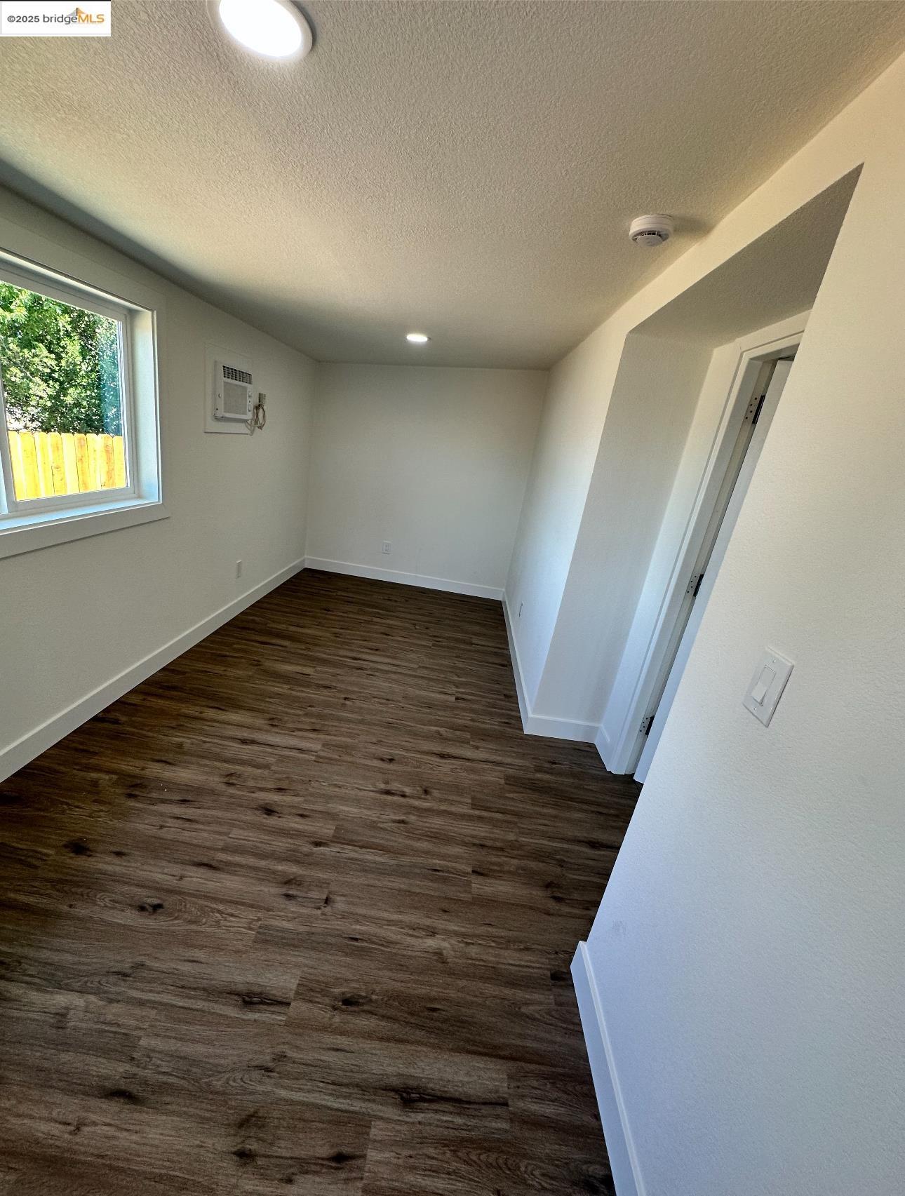 3301 Buchanan Road, Unit 47 Antioch, CA 94509 - Photo 45 of 58 a view of an empty room with wooden floor and stairs