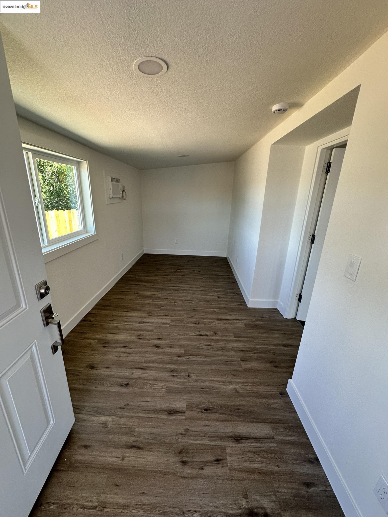 3301 Buchanan Road, Unit 47 Antioch, CA 94509 - Photo 46 of 58 a view of an empty room with wooden floor and a window