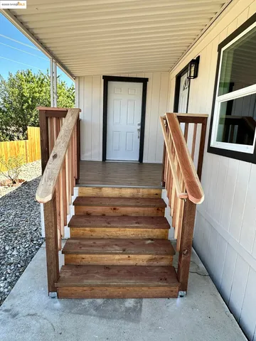 a view of a house with a wooden fence