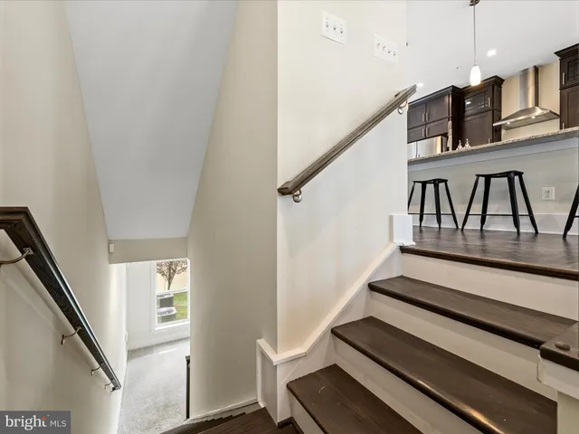 a view of a room with wooden floor and windows