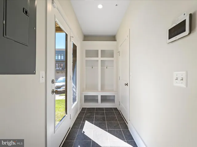 a view of a hallway with wooden floor and entryway