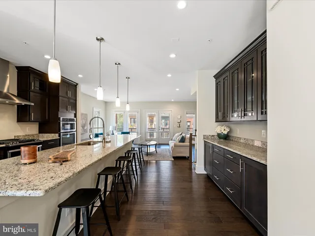 a kitchen with lots of counter space a sink appliances and dining table