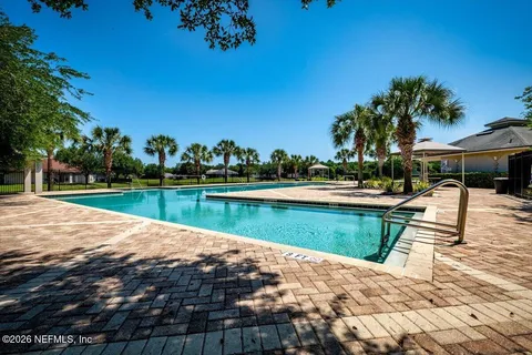 a view of a swimming pool with a yard