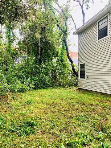 a view of a green field with lots of bushes