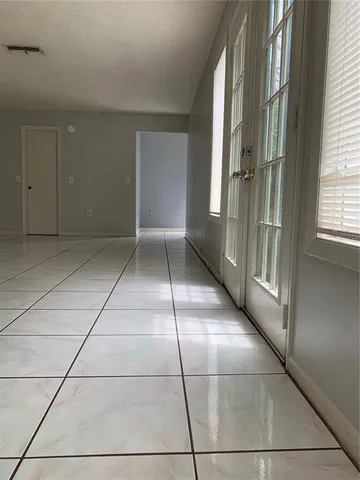 a view of a refrigerator in kitchen and entryway