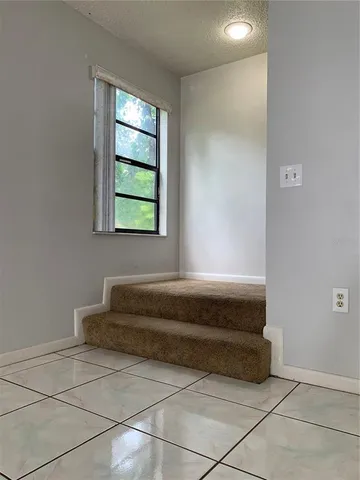 a spacious en suite bathroom with a bathtub and window