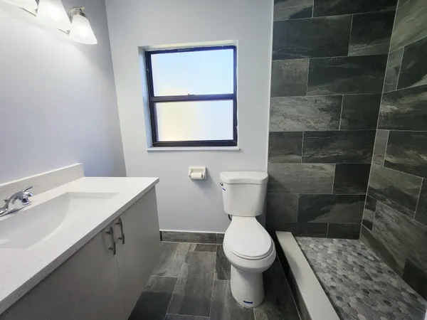 a bathroom with a toilet a sink and a shower