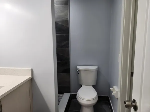 a white toilet sitting next to a sink