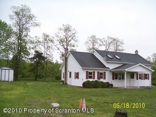 323 Bennett Road Meshoppen, PA 18630 - Photo 1 of 1 a front view of a house with a garden