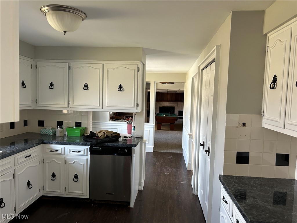 424 Ridge Road North North Fairfield, OH 44855 - Photo 6 of 48 Kitchen featuring stainless steel dishwasher, dark stone countertops, white cabinets, and backsplash