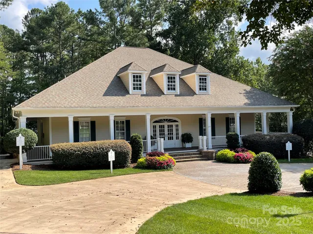 a front view of a house with a yard and outdoor seating