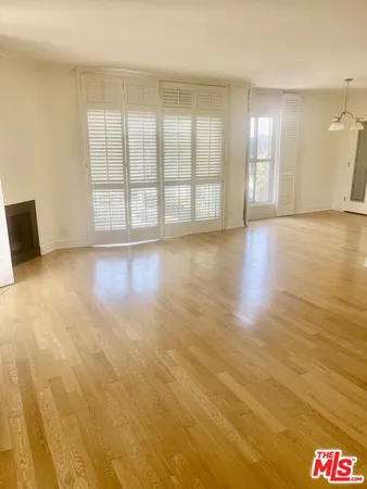 a view of an empty room with glass door