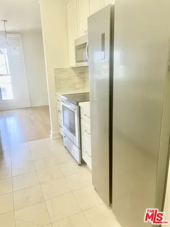 a bathroom with granite countertop shower and a sink