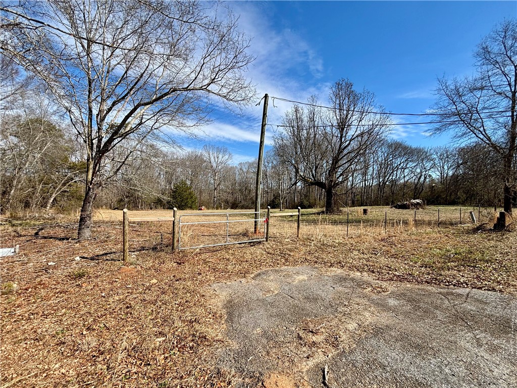 This lot offers a spacious, fenced area, perfect for various uses.