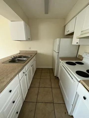 a kitchen that has a sink and a stove