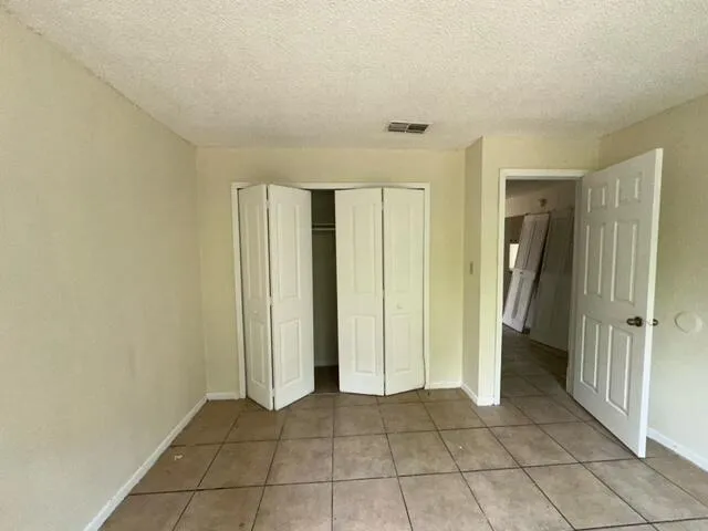 a view of an empty room with closet area