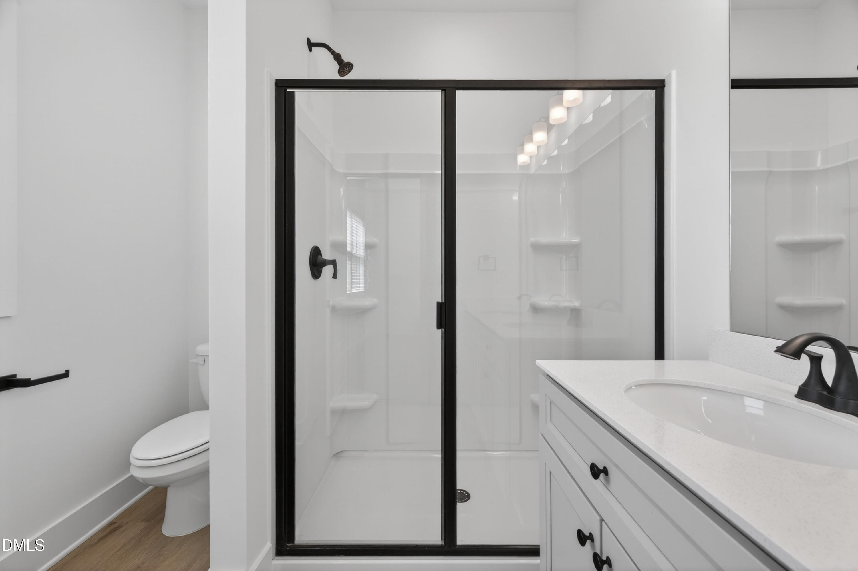 1196 Hurdle Mills Road Roxboro, NC 27573 - Photo 39 of 50 a bathroom with a sink a toilet and shower