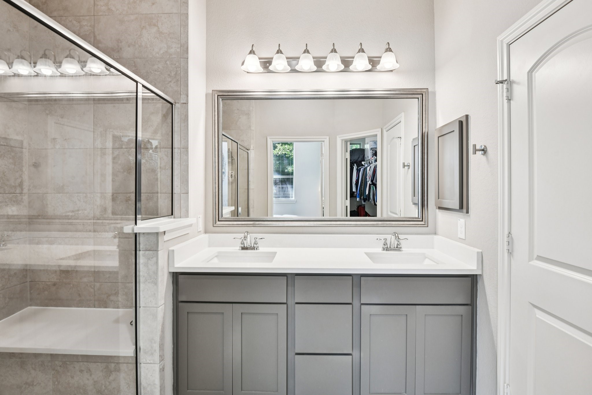 230 Biltmore Loop Montgomery, TX 77316 - Photo 20 of 39 Primary bathroom with dual sink vanity and large shower with bench seat.