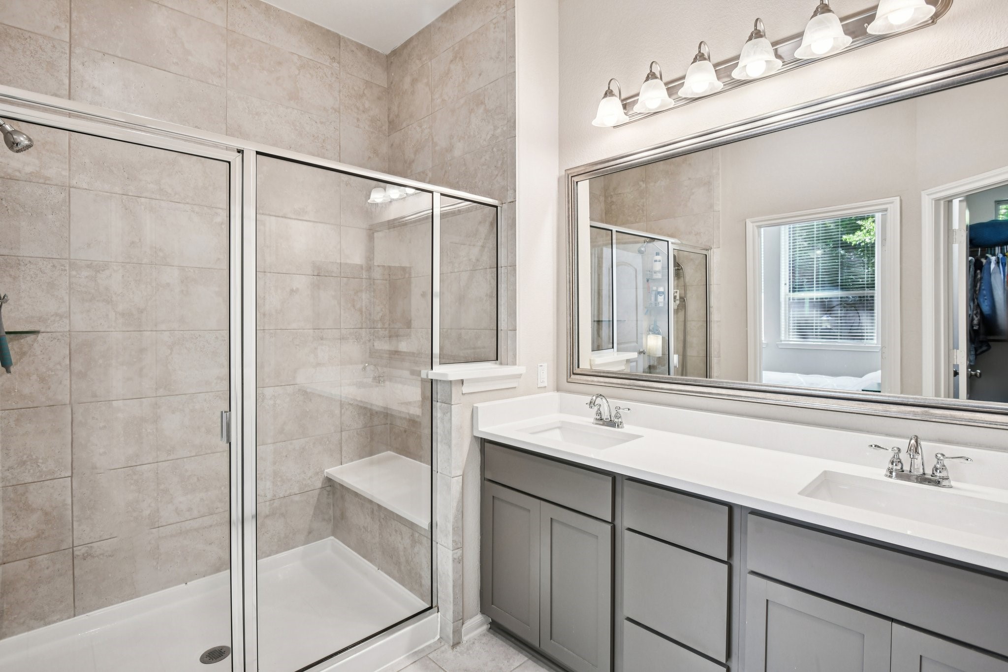 230 Biltmore Loop Montgomery, TX 77316 - Photo 21 of 39 Primary bathroom with dual sink vanity and large shower with bench seat.