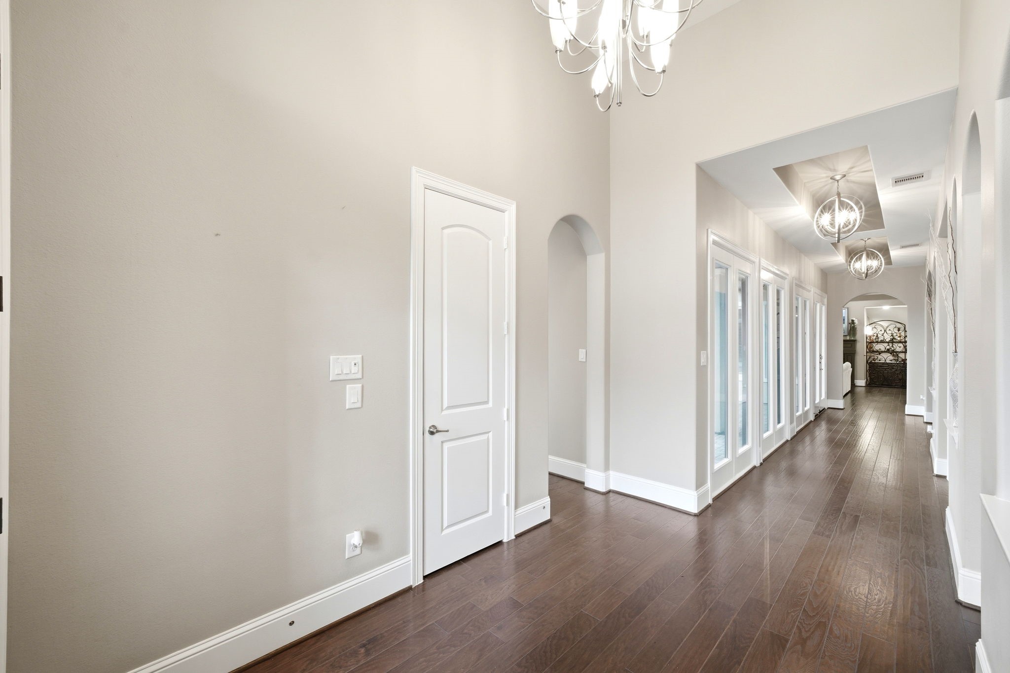 5815 Stratton Woods Drive Spring, TX 77389 - Photo 9 of 45 a view of a hallway with wooden floor and chandelier