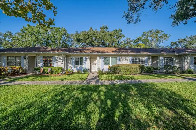a front view of a house with a yard table and chairs