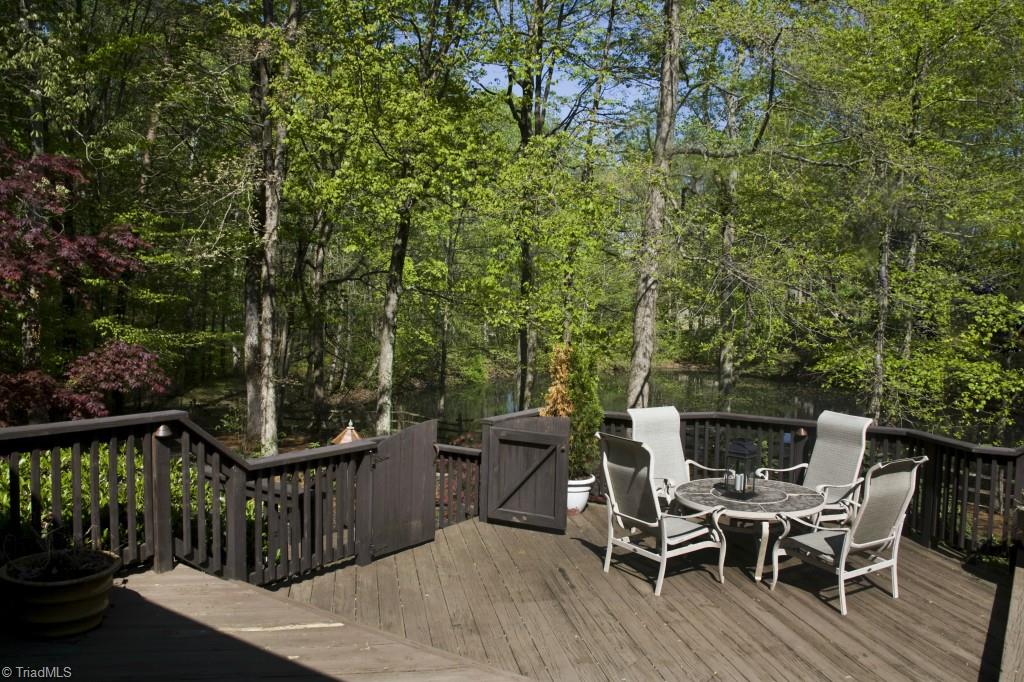 3701 Lewiston Road Greensboro, NC 27410 - Photo 18 of 30 The multi level deck overlooks the gardens and pond. The property is extremely private with trails leading back to the Greensboro Watershed Trail System.