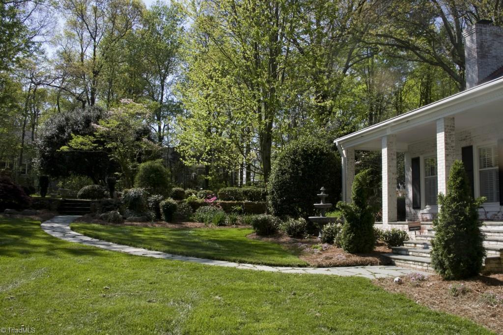 3701 Lewiston Road Greensboro, NC 27410 - Photo 19 of 30 Flagstone pavers lead to a wide covered porch with flagstone flooring. Outdoor lighting and fountains lead the way.