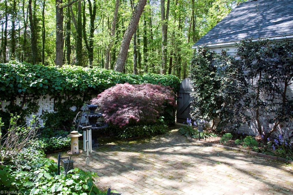 3701 Lewiston Road Greensboro, NC 27410 - Photo 23 of 30 The pierced wall courtyard with lavish landscaping. Brick patio and plenty of room for a garden party.