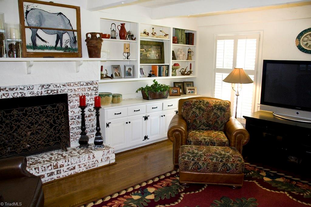 3701 Lewiston Road Greensboro, NC 27410 - Photo 6 of 30 Den/Great Room also has a gas fireplace, hardwood floors, beamed ceiling, wainscoting and great built-ins.