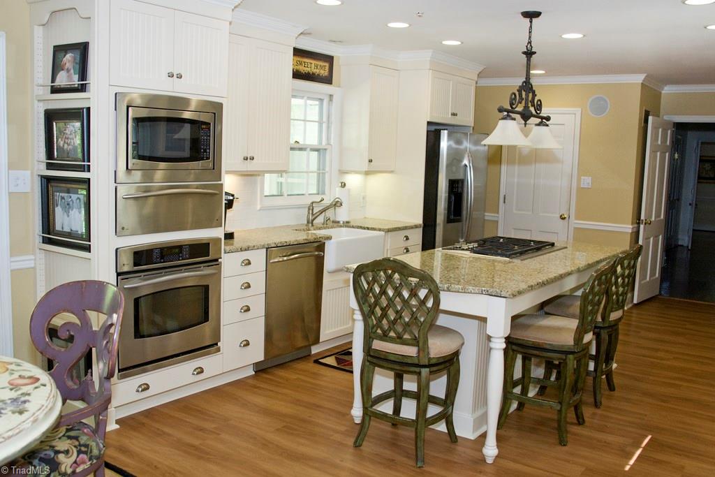 3701 Lewiston Road Greensboro, NC 27410 - Photo 8 of 30 Stainless appliances, including a warming tray, crown and chair rail molding, new cabinetry and hardware, and a sound system!