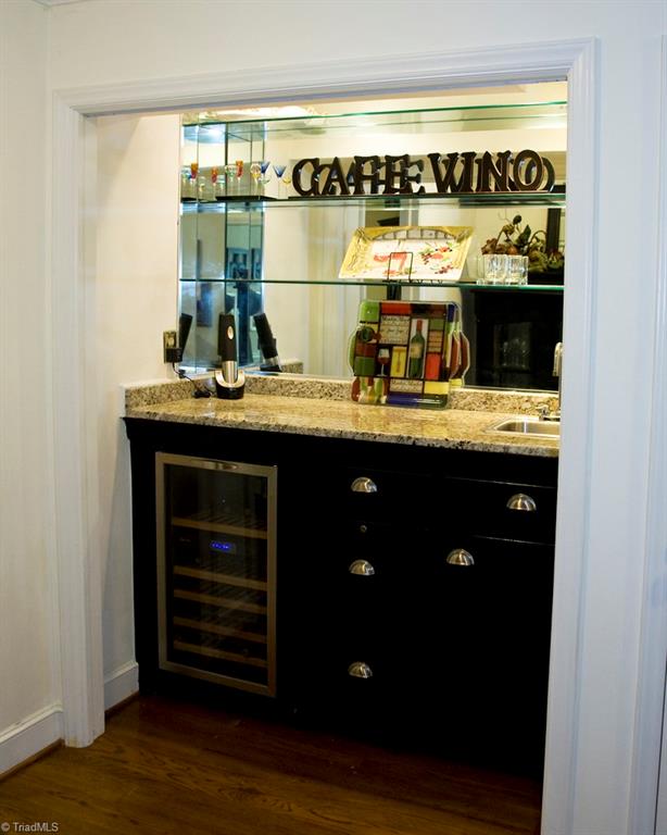 3701 Lewiston Road Greensboro, NC 27410 - Photo 10 of 30 The bar/bistro contains the wine cooler, another pantry closet for glassware and stocked beverages. The bistro table across the room offers a corner to have a nice cocktail before dinner.