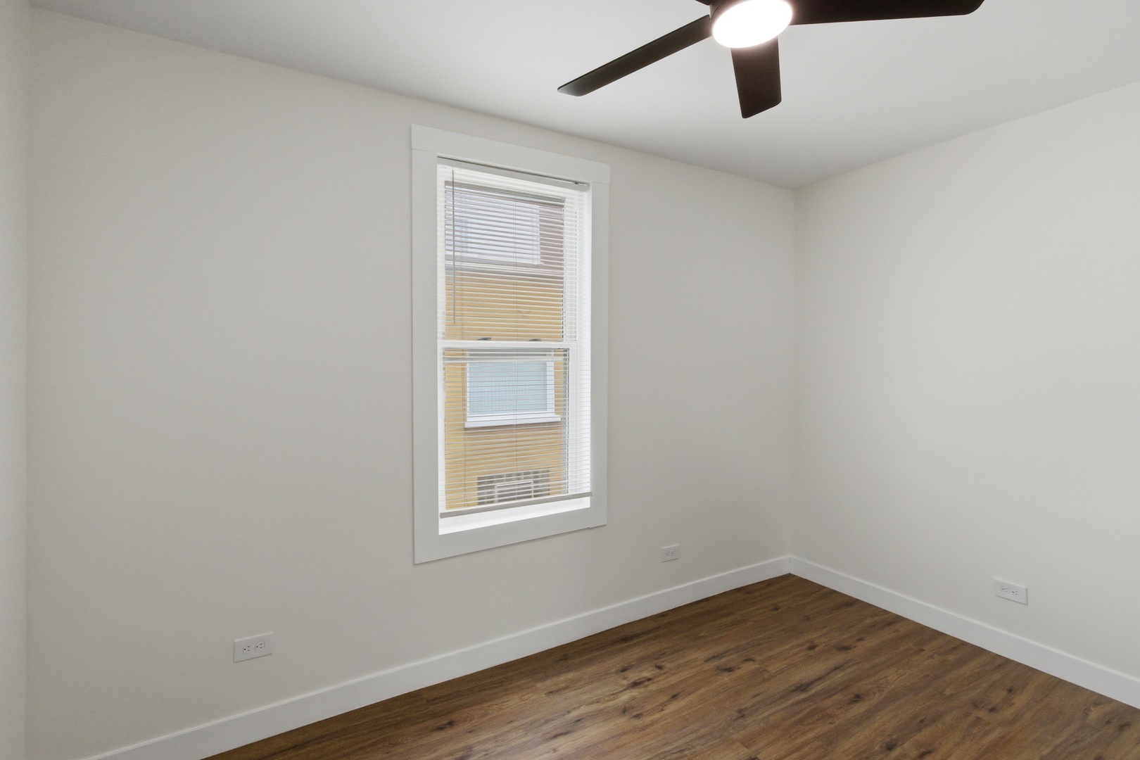 8942 South Aberdeen Street Chicago, IL 60620 - Photo 18 of 35 an empty room with wooden floor fan and windows