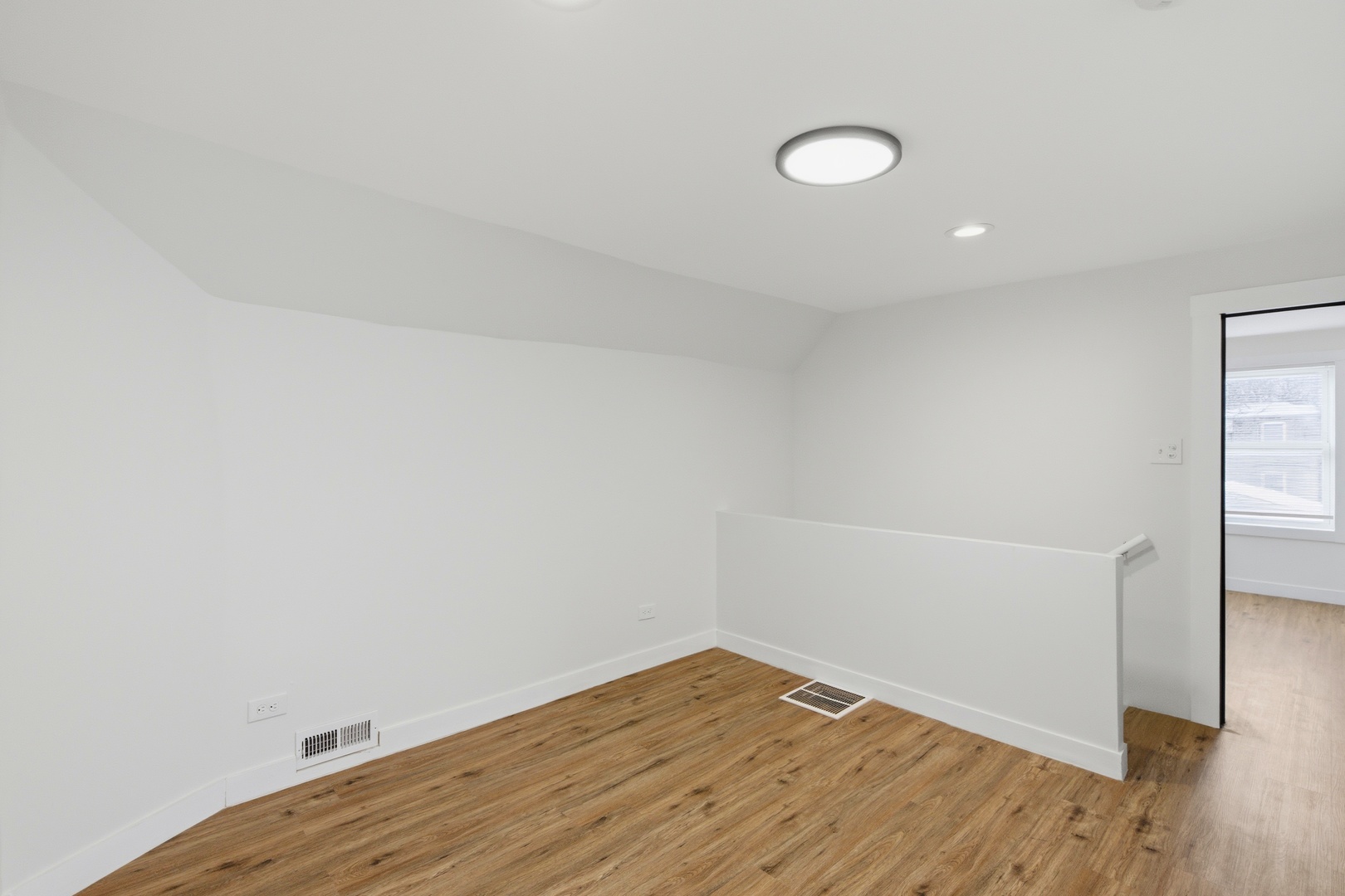 8942 South Aberdeen Street Chicago, IL 60620 - Photo 24 of 35 a view of a room with wooden floor and white walls