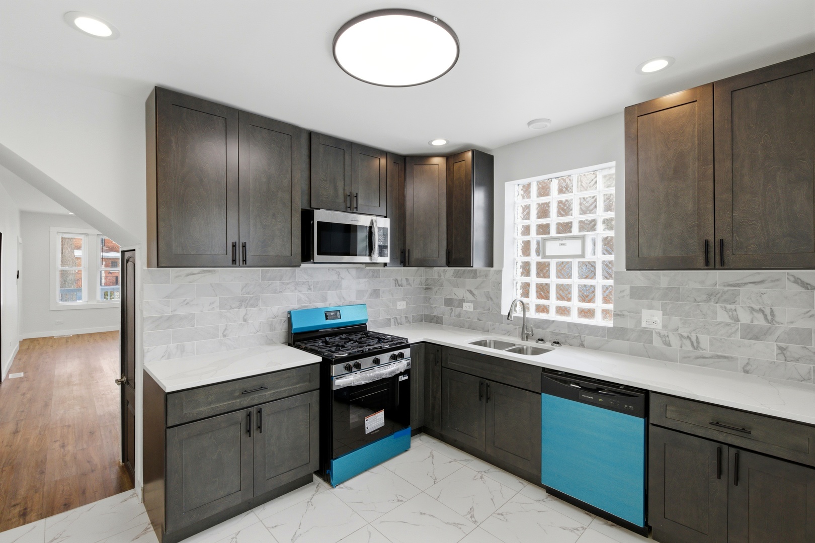 8942 South Aberdeen Street Chicago, IL 60620 - Photo 7 of 35 a kitchen with stainless steel appliances granite countertop a sink stove and cabinets