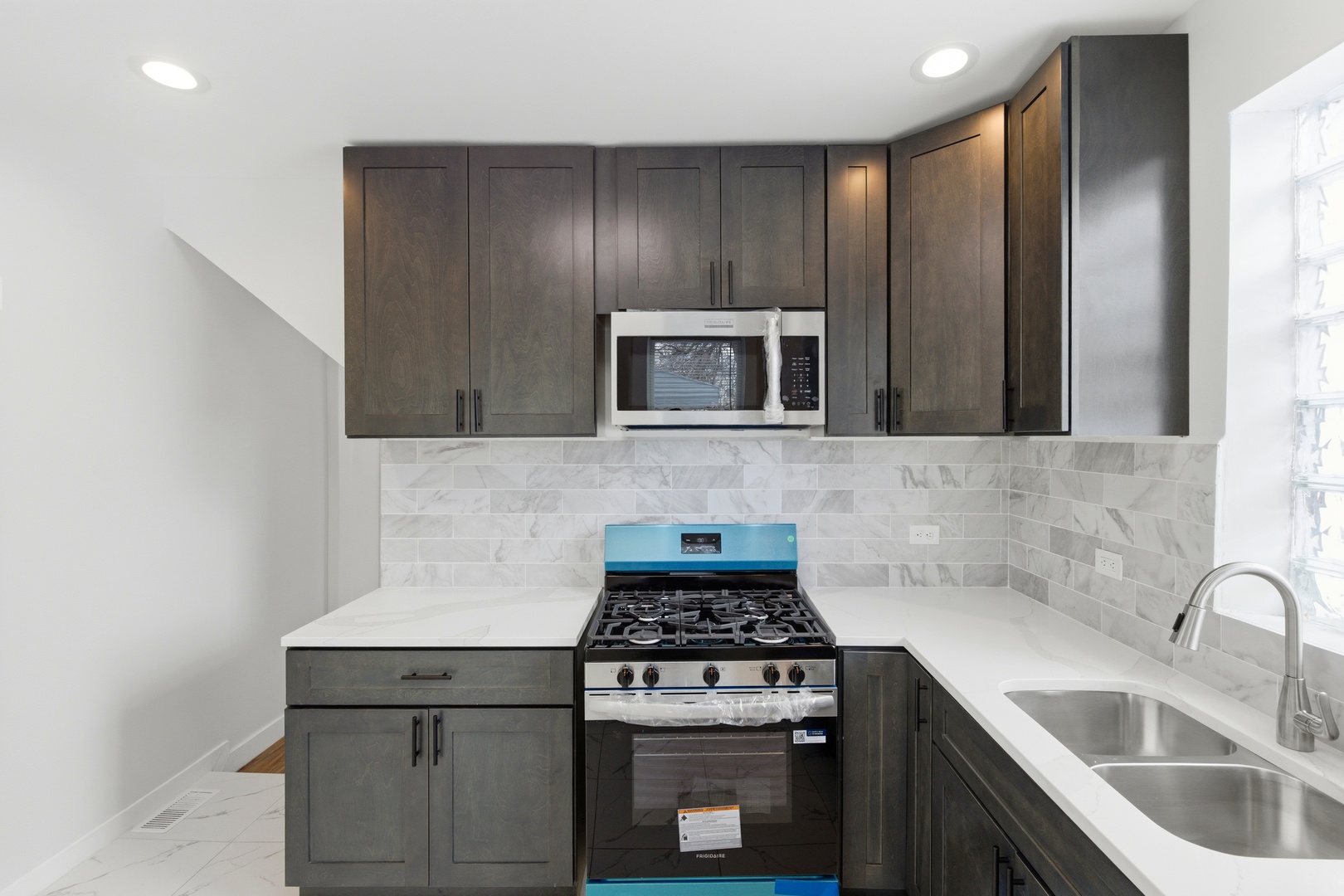 8942 South Aberdeen Street Chicago, IL 60620 - Photo 8 of 35 a kitchen with granite countertop stainless steel appliances a sink stove and microwave
