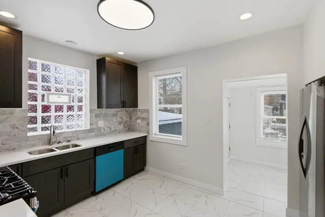a bathroom with a double vanity sink a toilet and a mirror