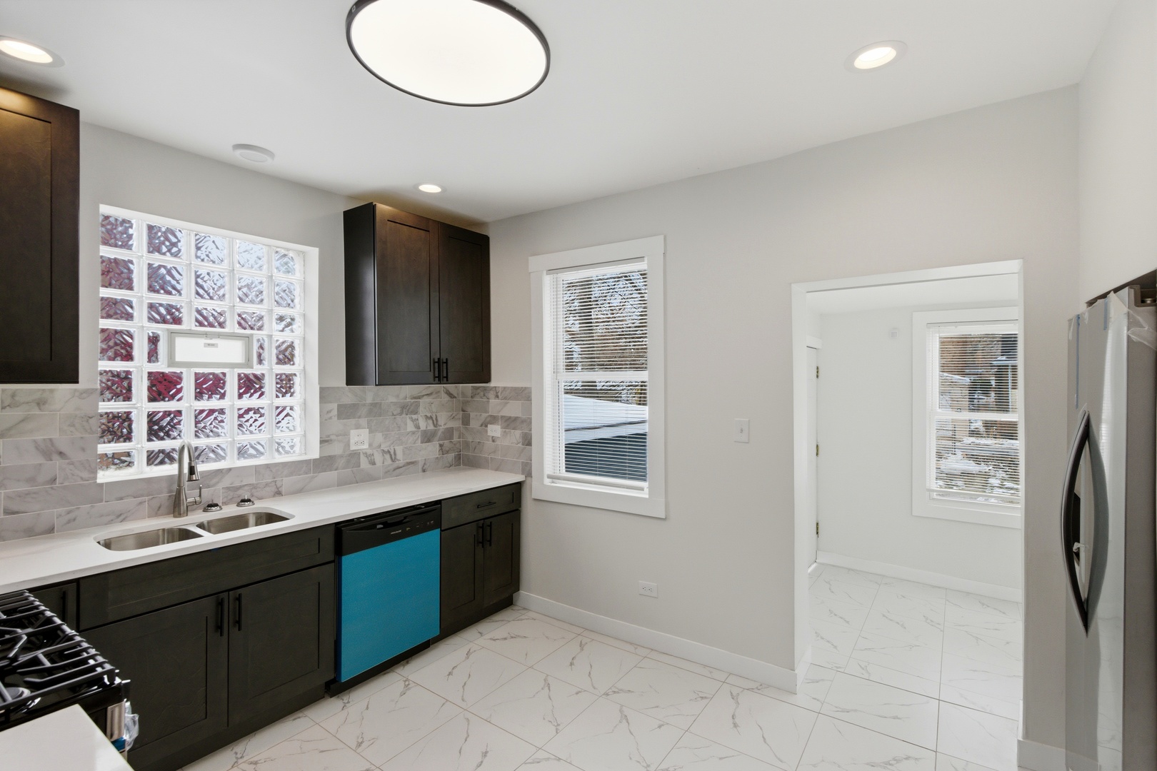8942 South Aberdeen Street Chicago, IL 60620 - Photo 9 of 35 a bathroom with a double vanity sink a toilet and a mirror