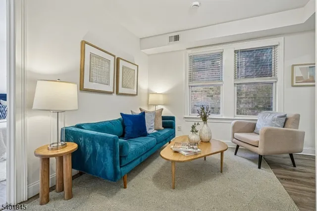 a living room with furniture a lamp and a window
