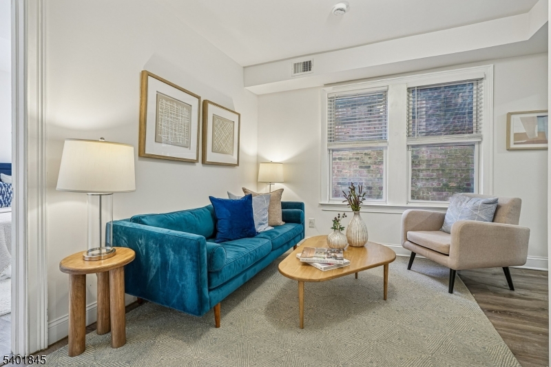 a living room with furniture a lamp and a window