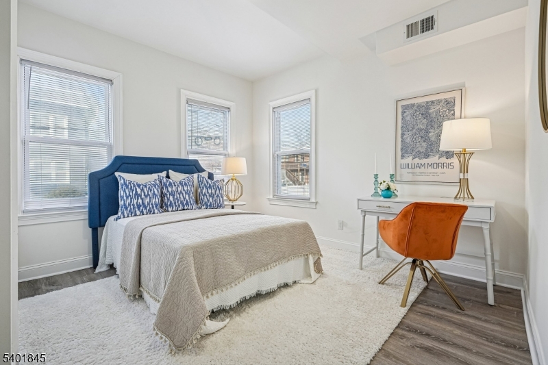 9 Wheeler Street Montclair, NJ 07042 - Photo 8 of 13 a bedroom with a bed a table and chair
