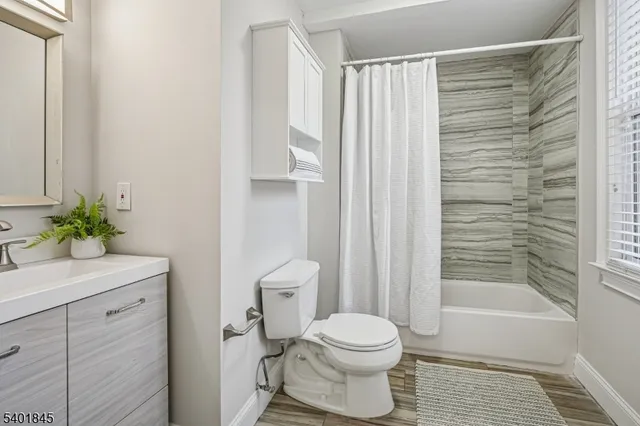 a bathroom with a toilet a sink and shower