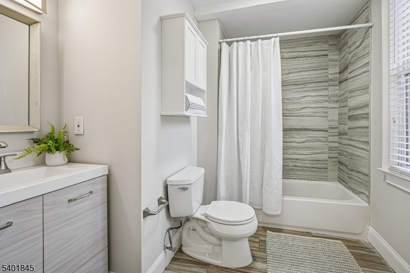 9 Wheeler Street Montclair, NJ 07042 - Photo 9 of 13 a bathroom with a toilet a sink and shower