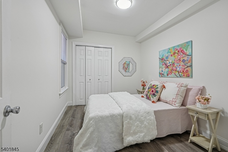 9 Wheeler Street Montclair, NJ 07042 - Photo 10 of 13 a bedroom with a bed and wooden floor
